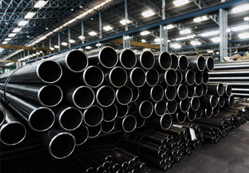 Large steel commerciial plumbing pipes stacked in a warehouse